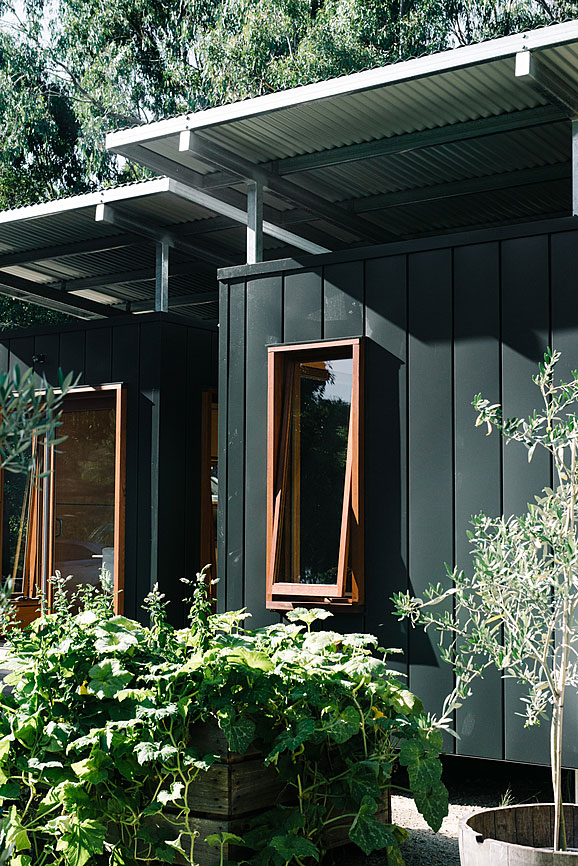 The wooden frames and surrounding plantings soften the harsh exterior. Source: AirBnB