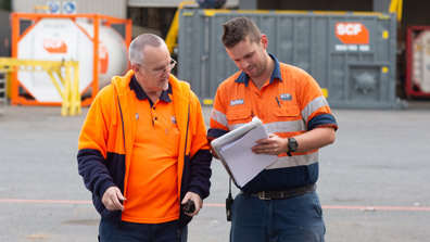 Two SCF depot workers inspecting paperwork