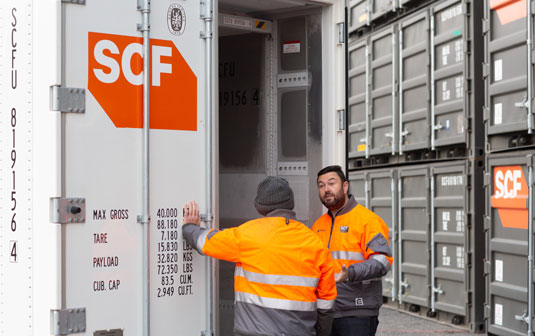 SCF employees discussing potential reefer container modifications