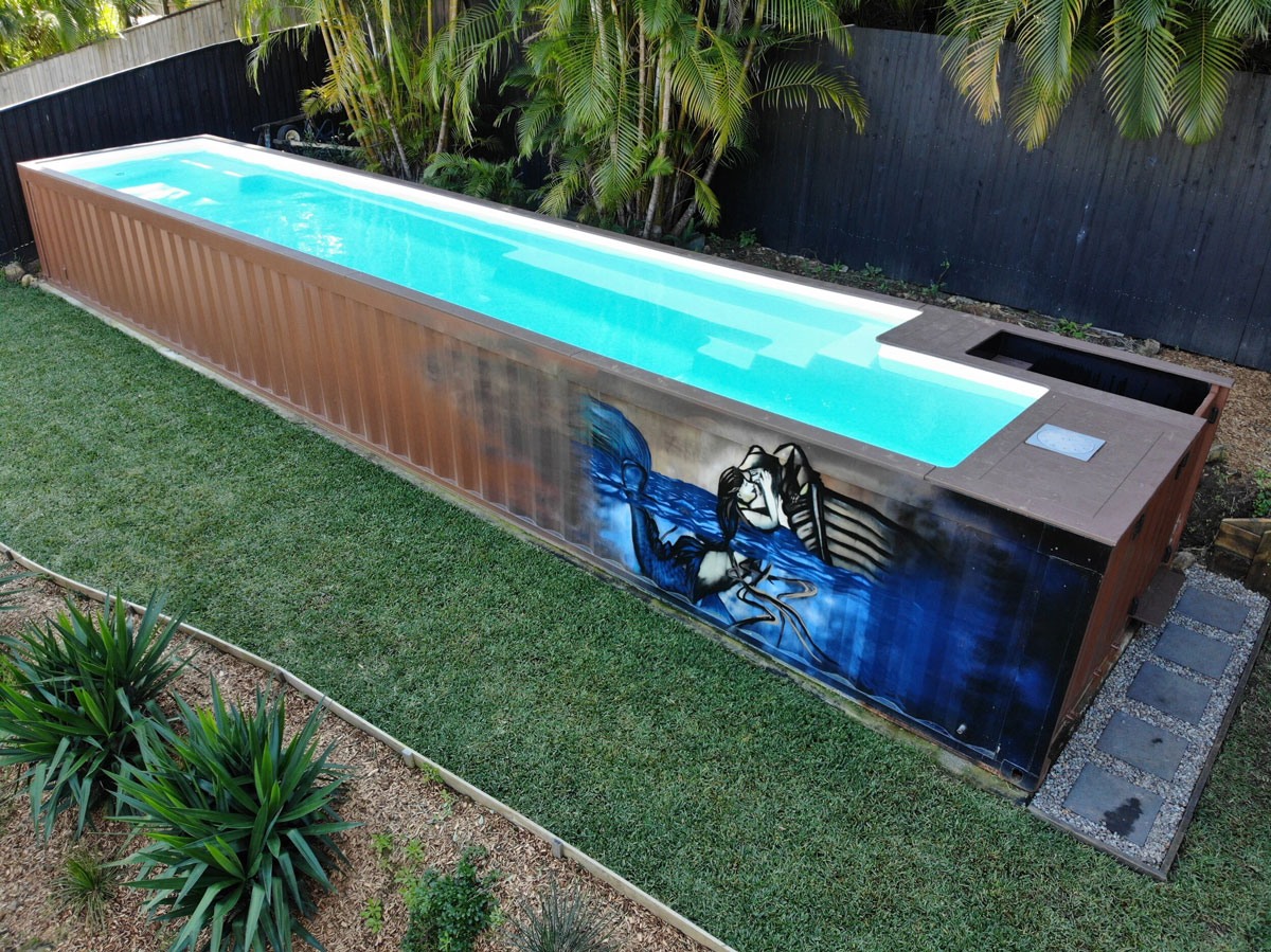 A container pool with a custom external display in a backyard.