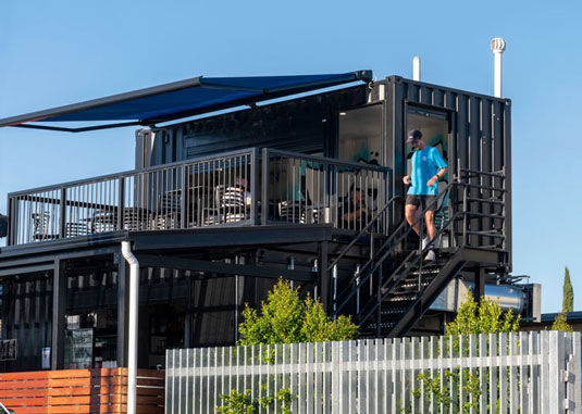 A cafe made out of multiple shipping containers