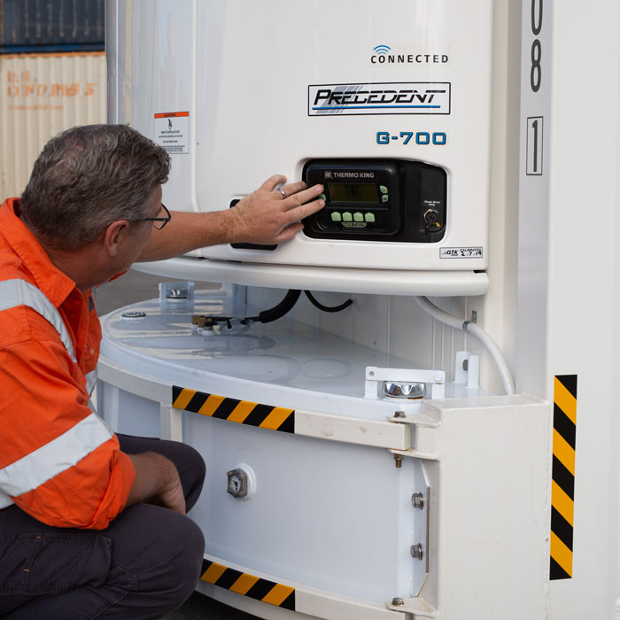 A SCF staff member operates a reefer container motor