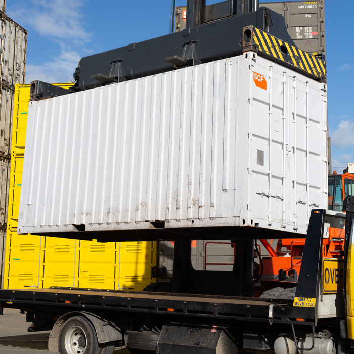 SCF container being loaded onto a tilt tray truck